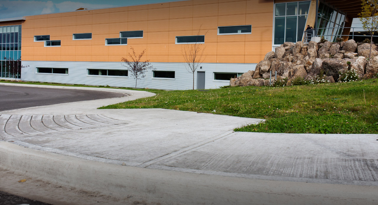 broom finished sidewalk with accessibility ramp and curb